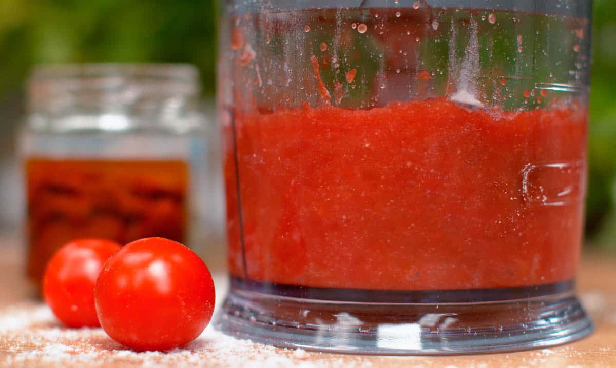 Pureed tomatoes in glass bowl.