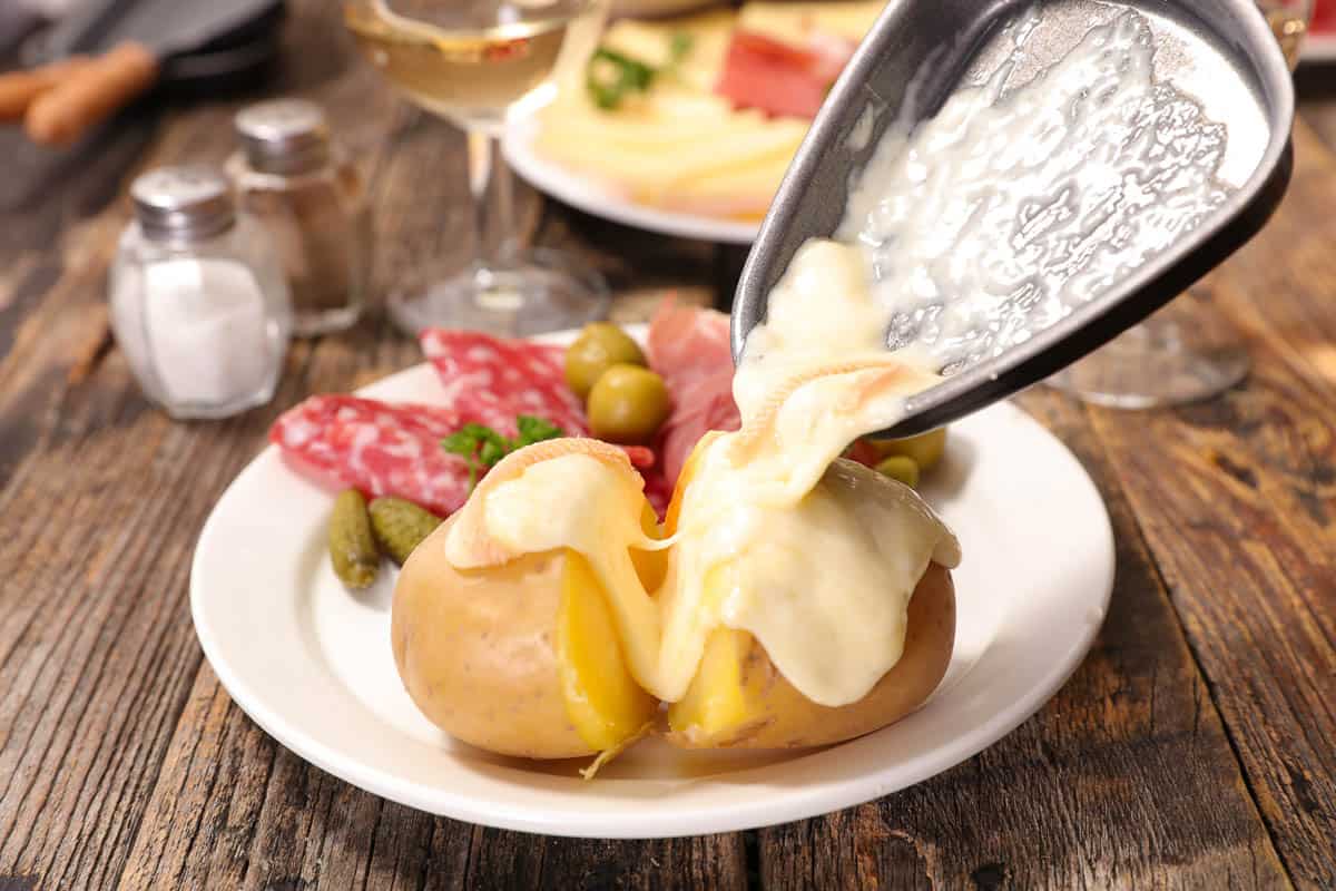 raclette cheese melted over a potato.