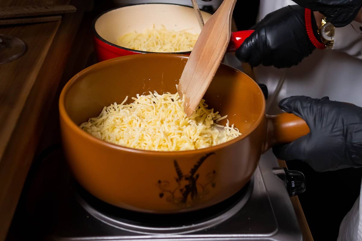 Melting Swiss cheese for making fondue.