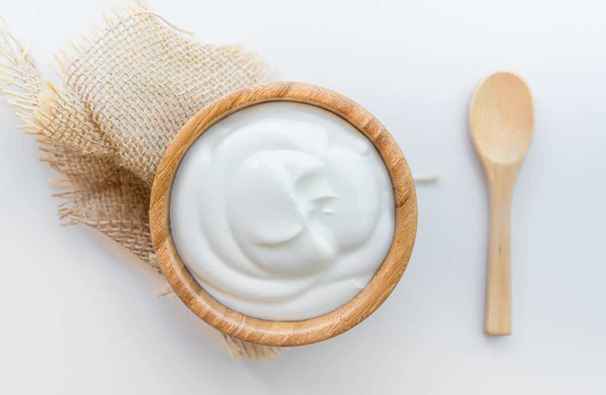 Greek yogurt in wooden bowl.